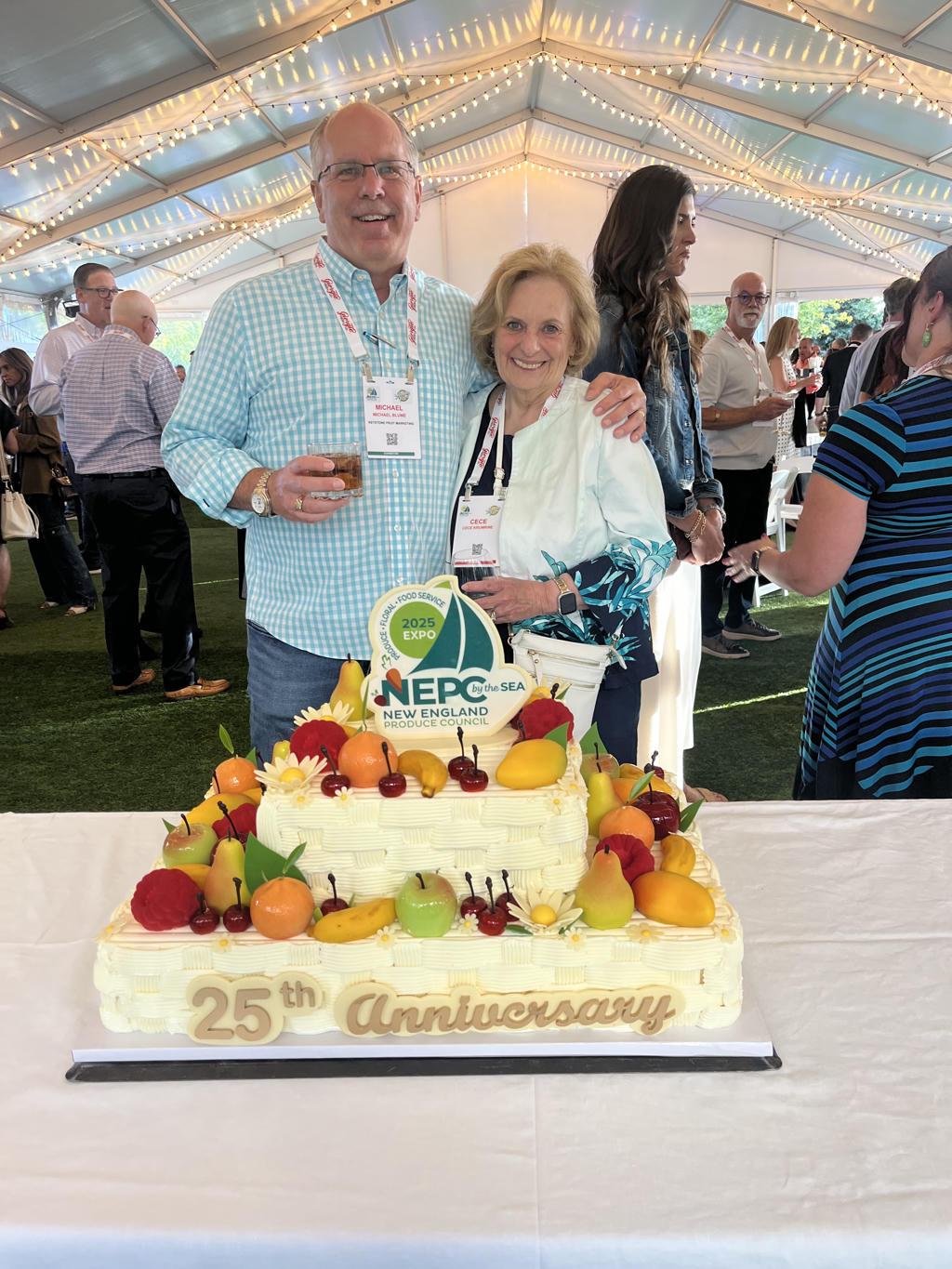 Couple celebrates 25th anniversary with a decorated cake at a festive event.